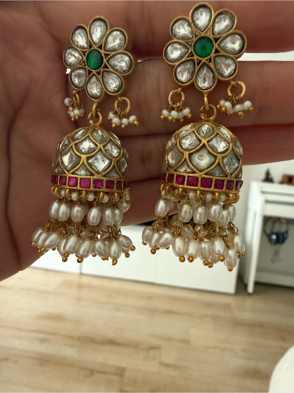 Gold Kundan Jhumka Earrings with Pearls and Green Accent